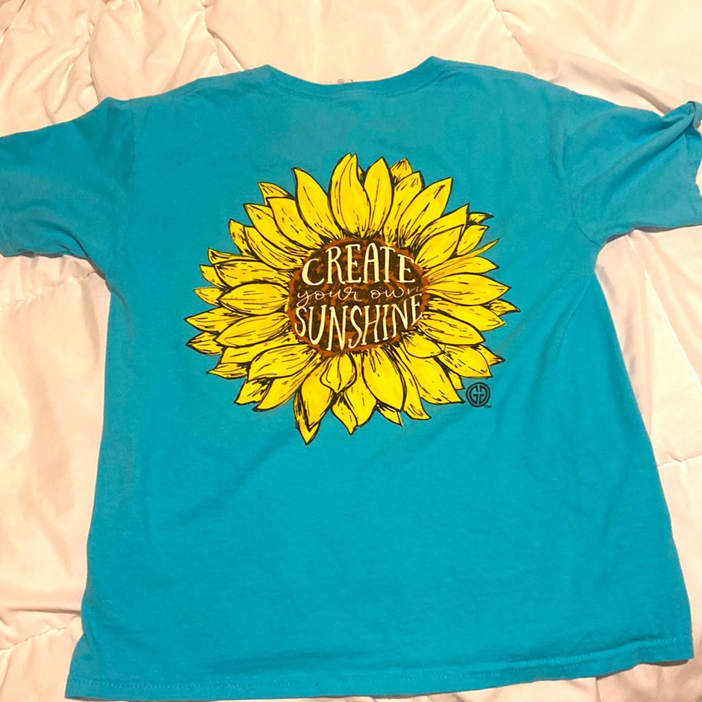 This shirt is a girlie girl sunflower shirt that is in good condition